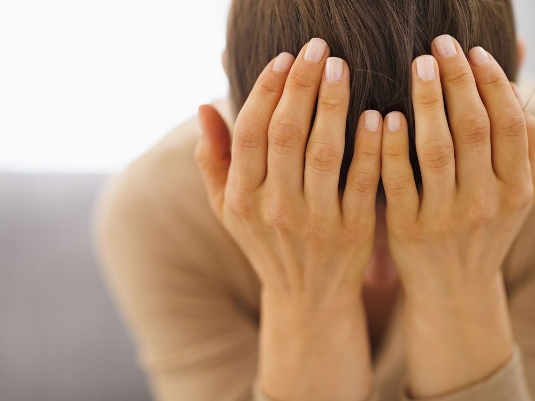 woman in grief, head in hands